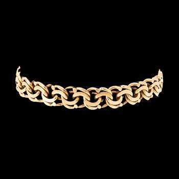 An 18K gold bracelet.