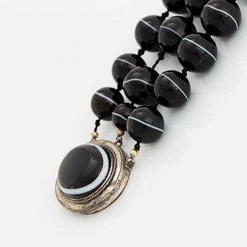 A banded agate and silver parure comprising a necklace, a bracelet, two pair of earrings and a brooch.