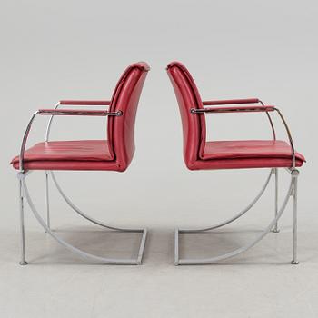 A pair of crome and leather 1970/80s armchairs.