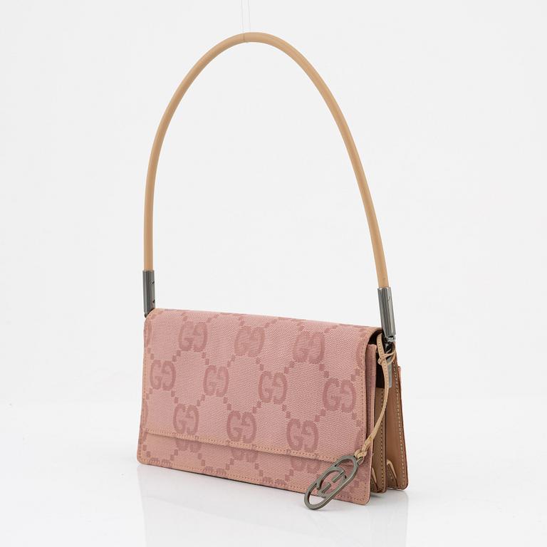 Gucci, a pink canvas handbag.