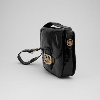 CÉLINE, a black patent leather shoulder bag.