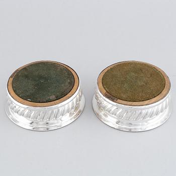 A pair of silver plated coasters.