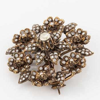 A brooch flower with rose-cut diamonds.