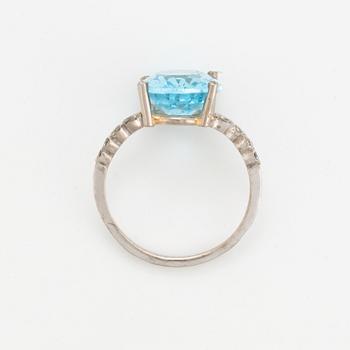 Oval faceted blue topaz and brilliant-cut diamond cocktail ring.
