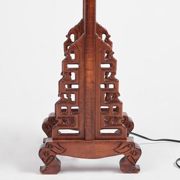 A Chinese wooden floor lamp, later part of the 20th century.