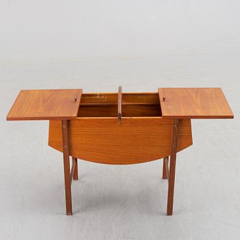 A mid 20th century teak sewing table.