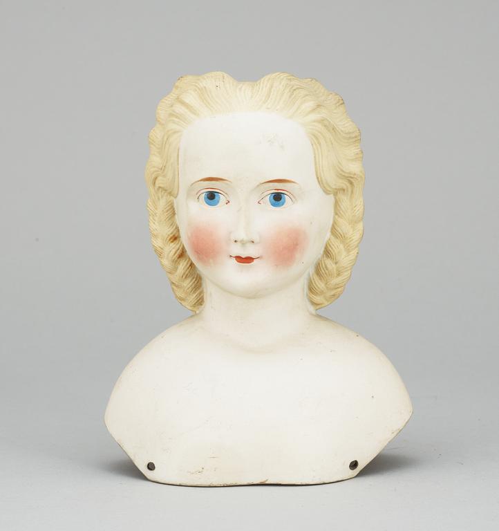 A 1860s-70s doll head, probably Germany.