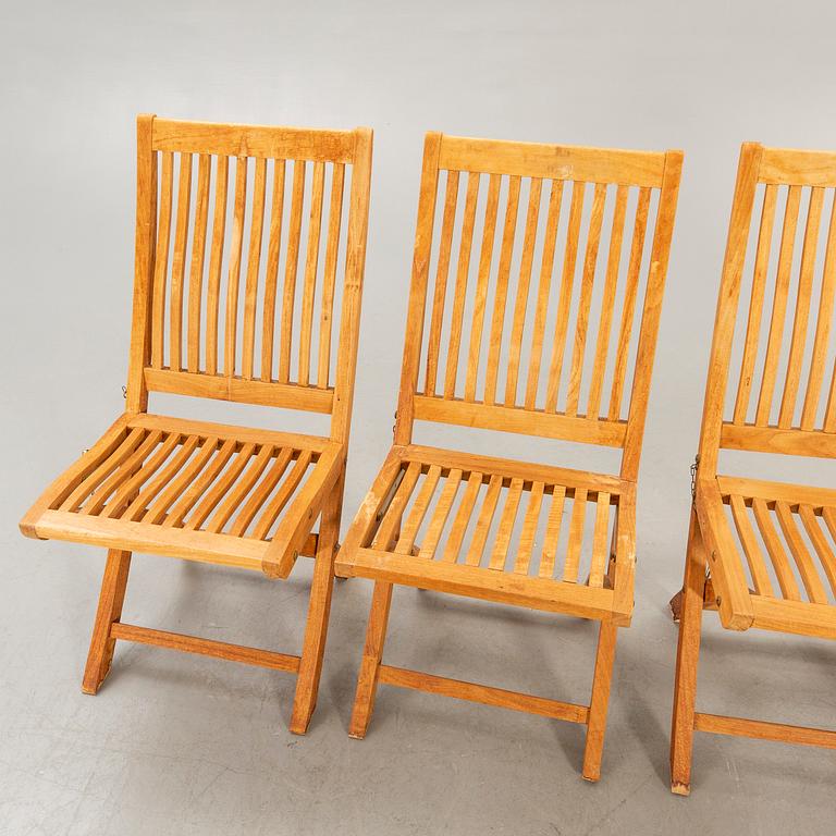 A set of four chairs and a table Royal teak and others, later part of the 20th century.