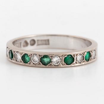 An emerald and diamond ring.