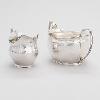 An early 19th-century, sterling silver sugar bowl, mark of Elizabeth Morley, and a cream jug, marked A.B, London 1808.