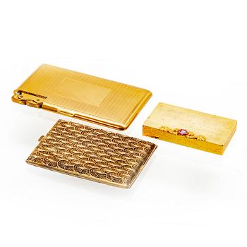 A set of three 20th century gold metal cigaret cases.