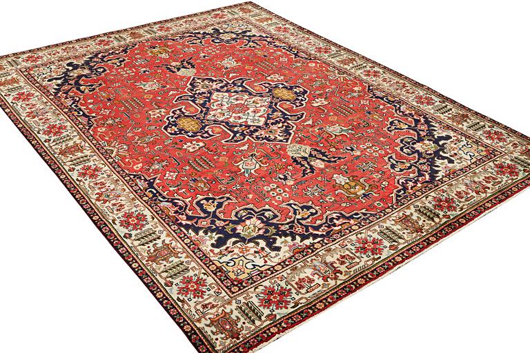 A Tabriz carpet, c. 335 x 257 cm.