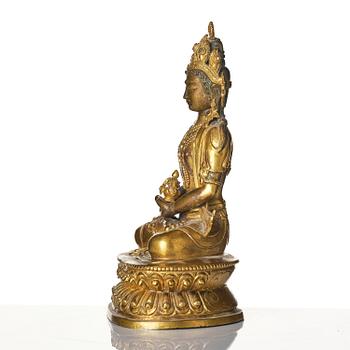 A gilt copper alloy figure of Amitayus, Tibet, 17th/18th century.