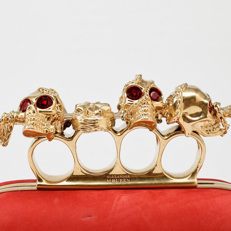 ALEXANDER MCQUEEN, a red nubuc leather "Knucklebox Clutch".