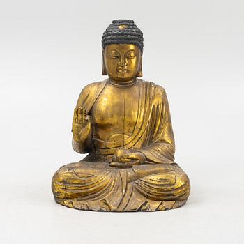 A massive gilded wooden figure of buddha, 20th century.
