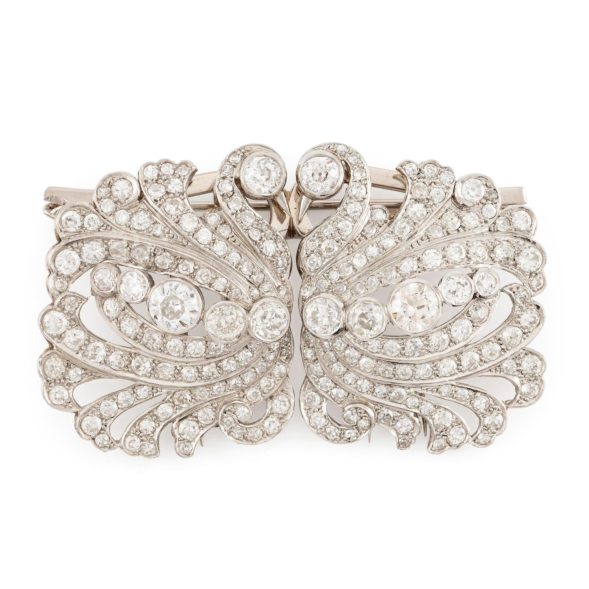A brooch/double clip in platinum set with old- and eight cut diamonds.