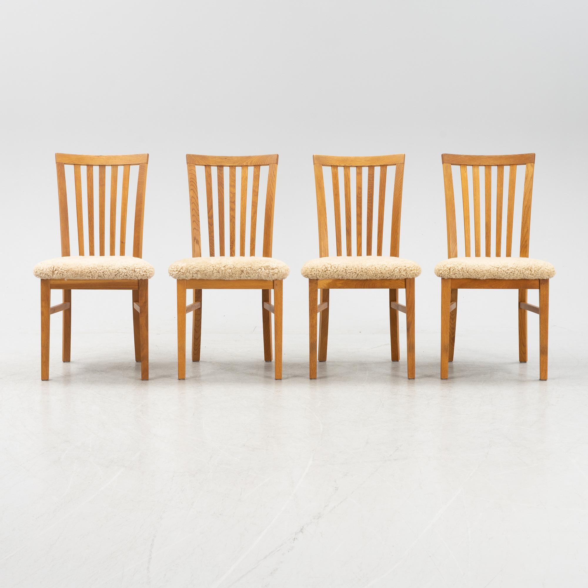 A set of four oak chairs with new  sheepskin upholstery.