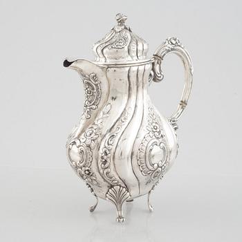 A Rococo-style silver coffee pot, creamer and sugar bowl, 20th Century.