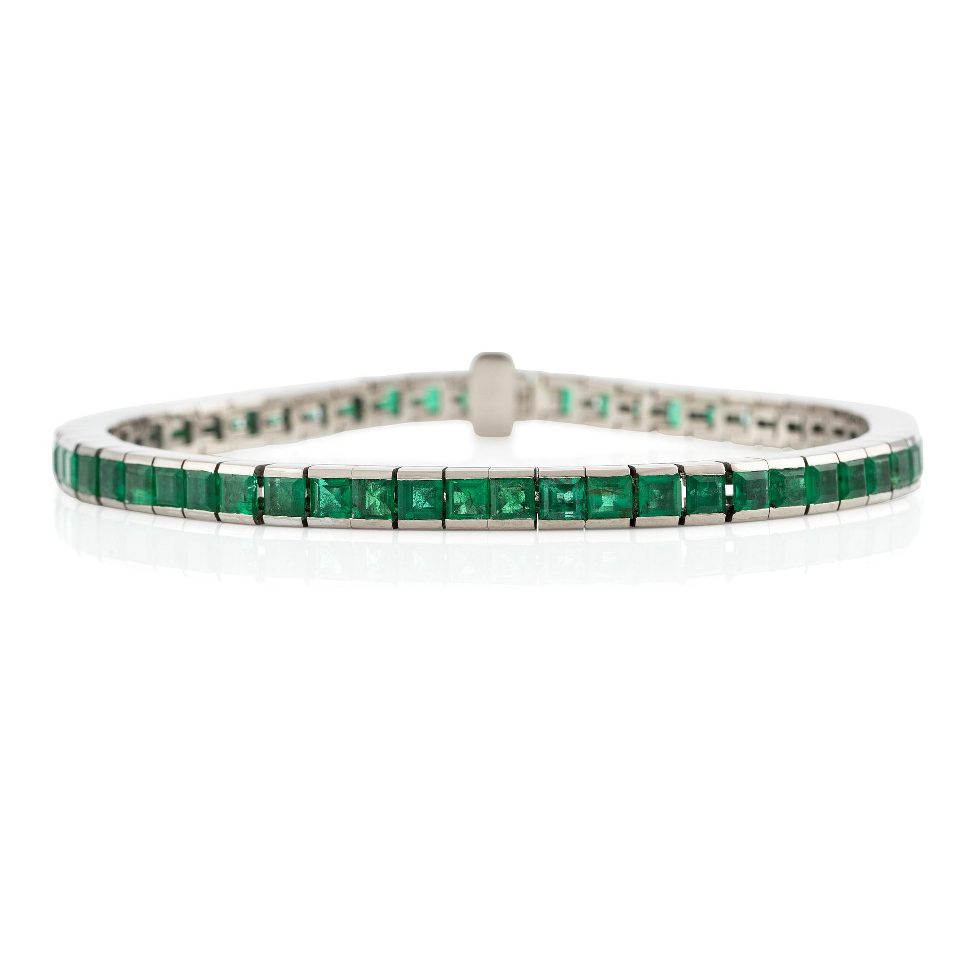 An 18K white gold bracelet with step-cut emeralds.