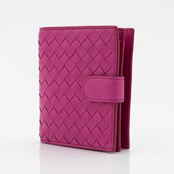 Bottega Veneta, a cerise leather wallet.
