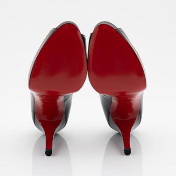 Christian Louboutin, a pair of black leather peep toe pumps, size 37 1/2.