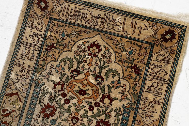 A Hereke silk rug, c. 73 x 52 cm.