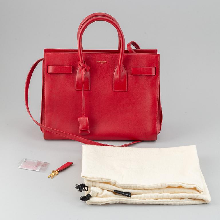 Saint Laurent, a red leather 'Sac du Jour Small' bag.