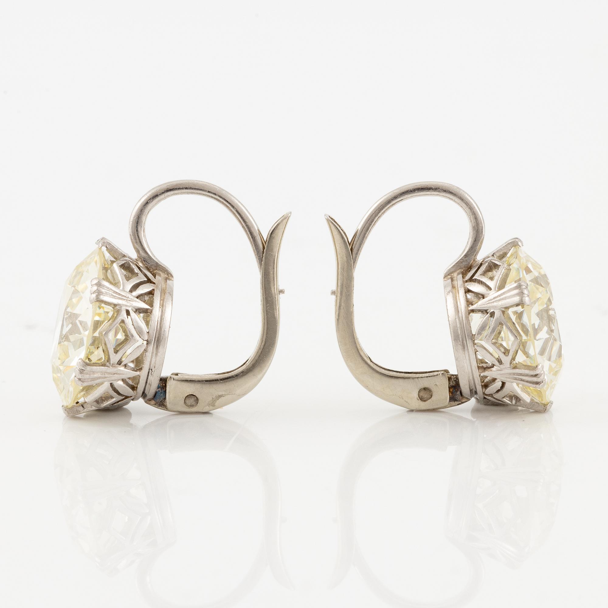A pair of earrings in 18K white gold set with two old-cut diamonds.