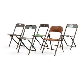 A set of five folding chairs.