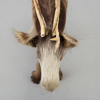 A Sami reindeer fur figure of a reindeer.