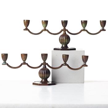 GULDSMEDSAKTIEBOLAGET (GAB), a pair of Swedish Grace patinated bronze candelabra, Stockholm 1930's.