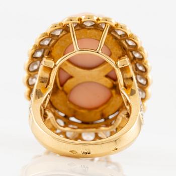 An 18K gold and coral Cartier ring set with round brilliant-cut diamonds.
