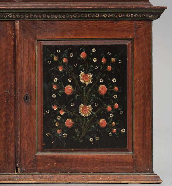 A Swedish polychrome painted folk art corner cabinet, dated 1818.