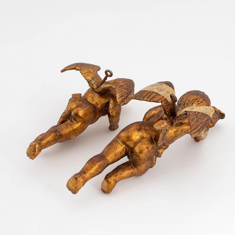 A pair of baroque wooden cupid sculptures, 18th century.