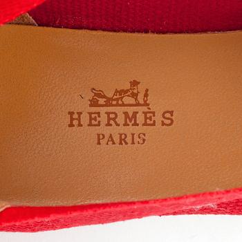 HERMÈS, a pair of red canvas espandrillos. Correlates to size 38 approximately.