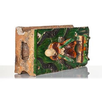 A green and yellow glazed architectural element with a Lohan, Ming dynasty (1368-1644), dated 1536.