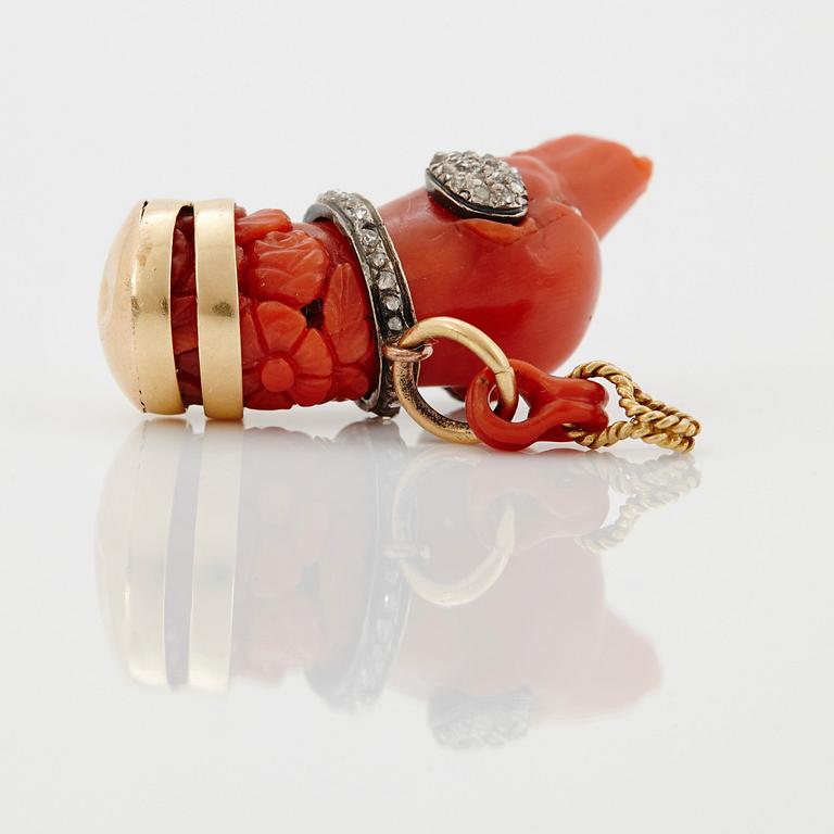 A 14 K gold and silver pendant with carved coral set with rose-cut diamonds.