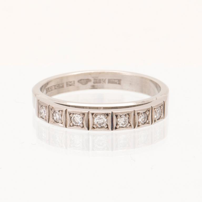 An 18K white gold ring set with round single cut dimamonds.