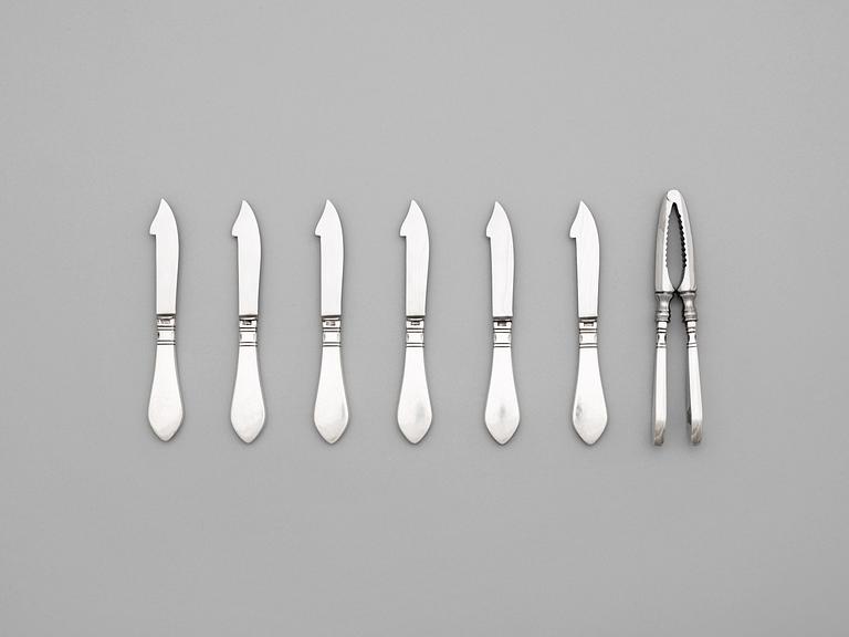 A set of six Georg Jensen sterling shell fish knives and a nut cracker, 'Continental', Copenhagen 1933-44 and 1930.