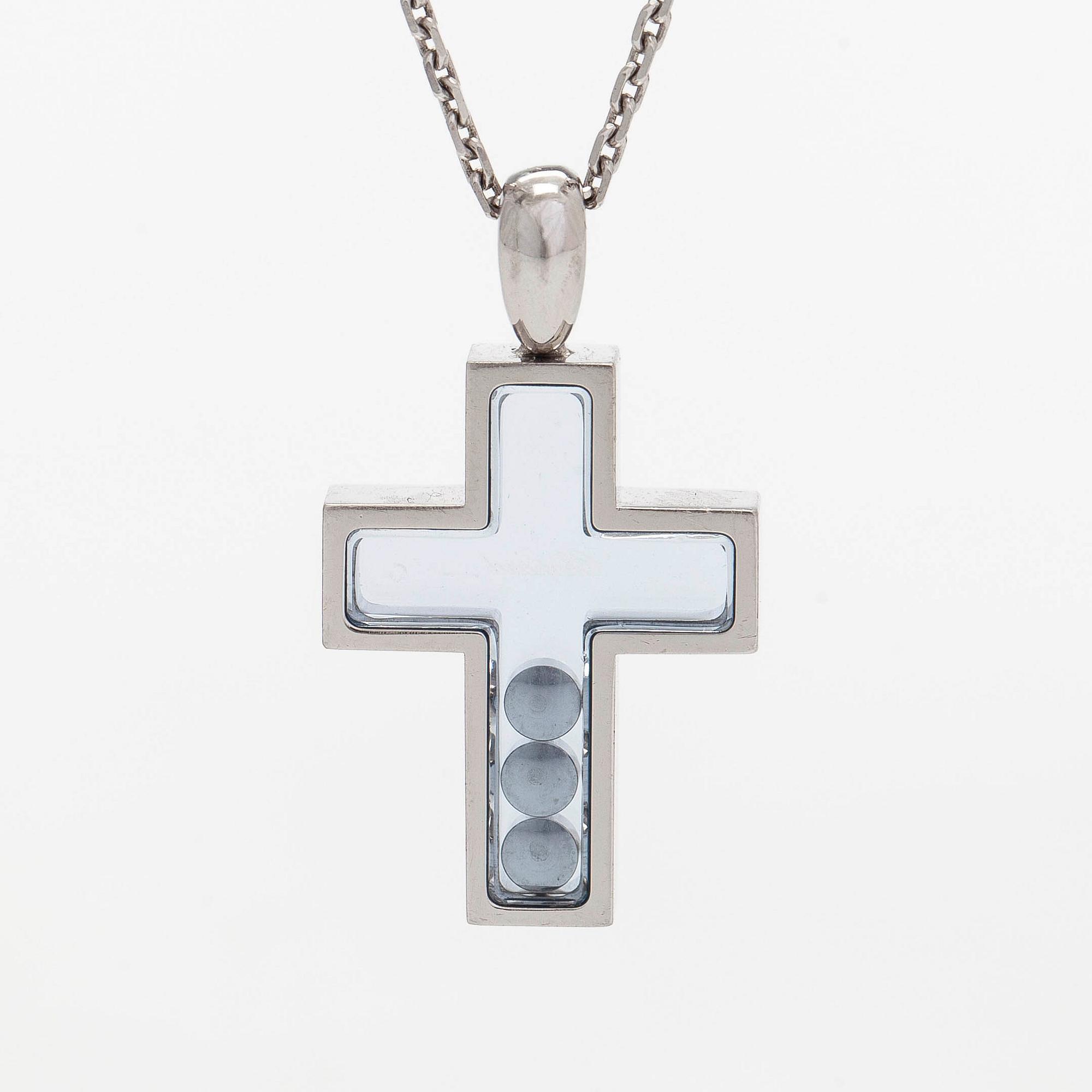 Chopard, an 18K whitegold 'Happy Diamonds" cross necklace set with diamonds.