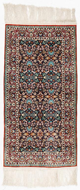 An oriental, silk rug, c. 123 x 63 cm.