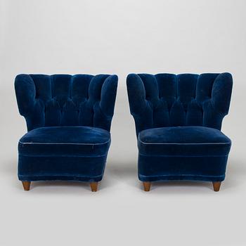 A pair of mid-20th century armchairs.