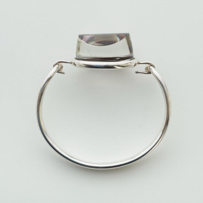 A Torun Bülow Hübe sterling bangle with a cut graal glass lock, ca 2001.
