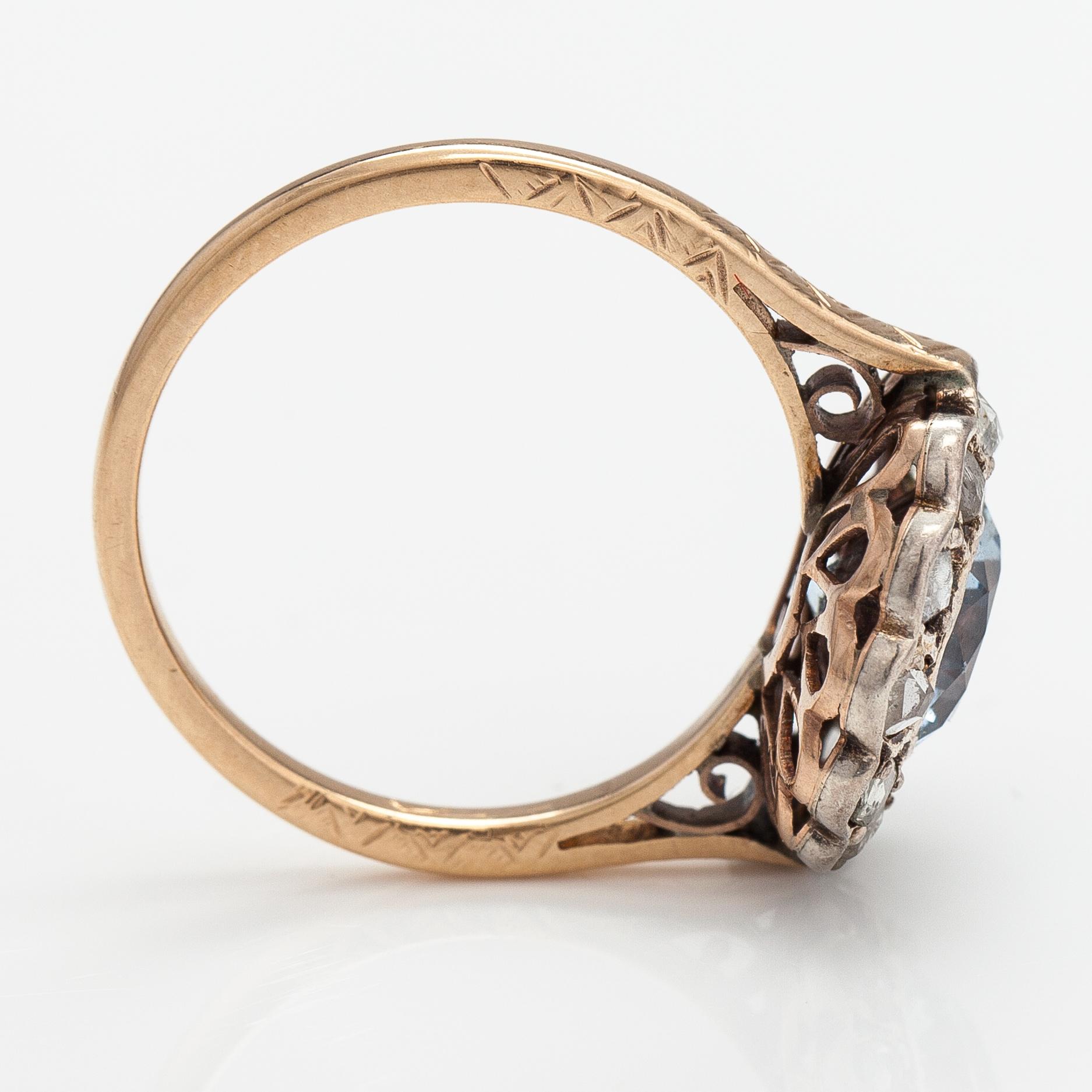 A 13-14K gold ring with a synthetic spinelle and rose-cut dimaonds.