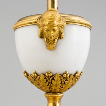 A late 19th century French Louis XVI-style marble and brass table lamp.