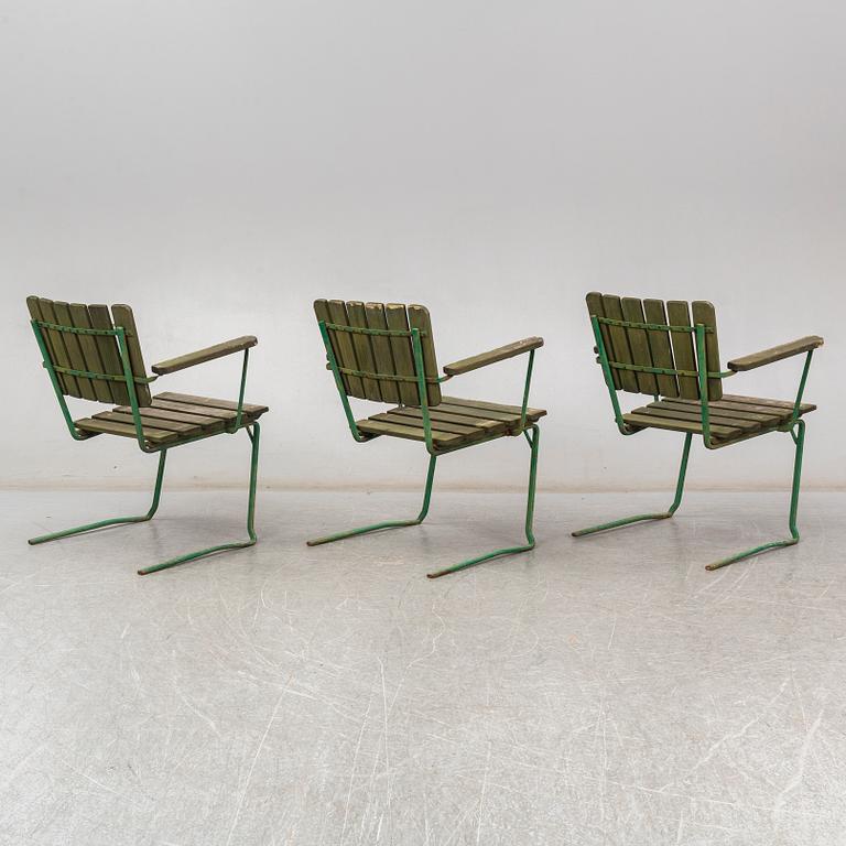 Three Arbrå stålmöbler and Grythyttan garden armchairs and a table, mid 20th century.