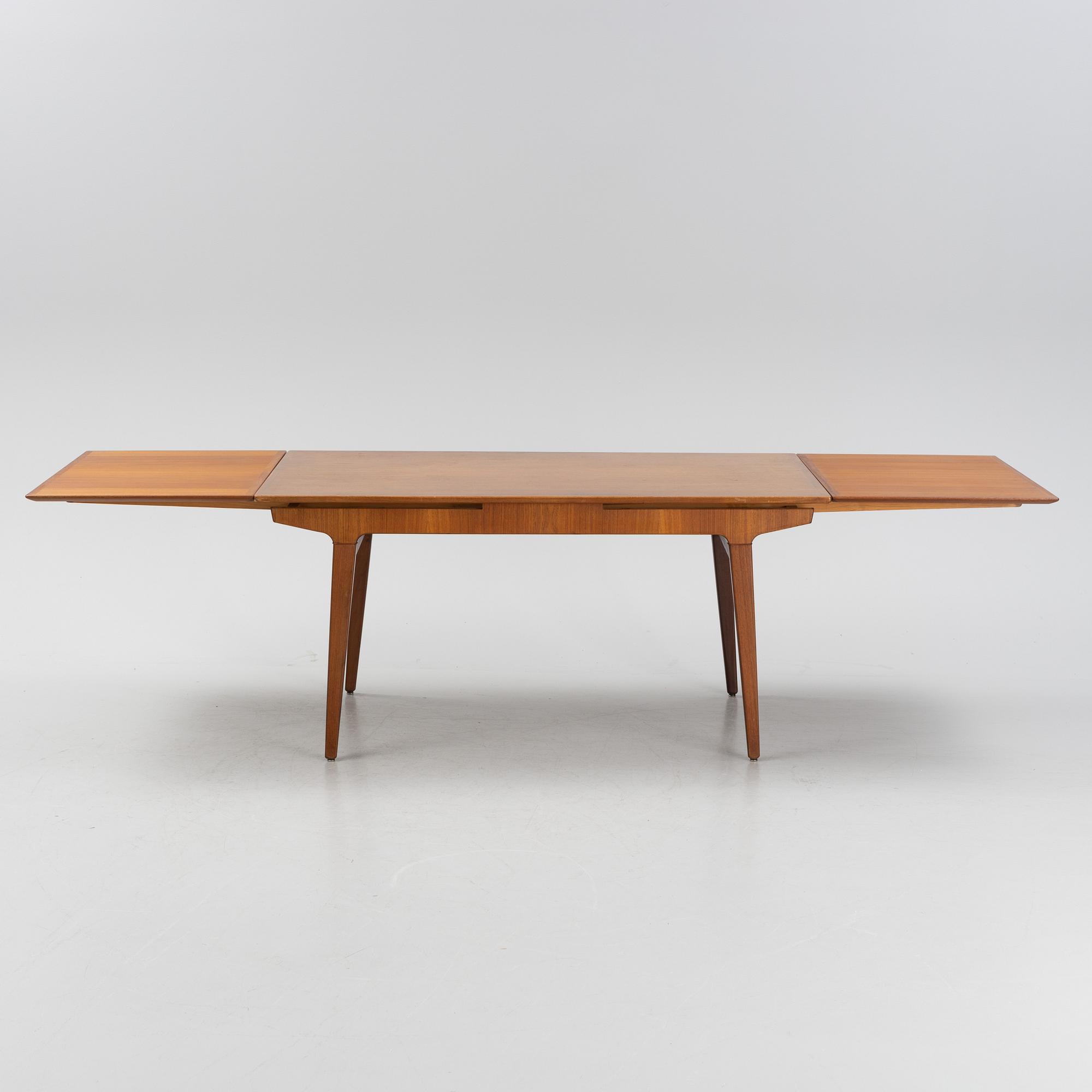 A 1960s teak veneer dining table.