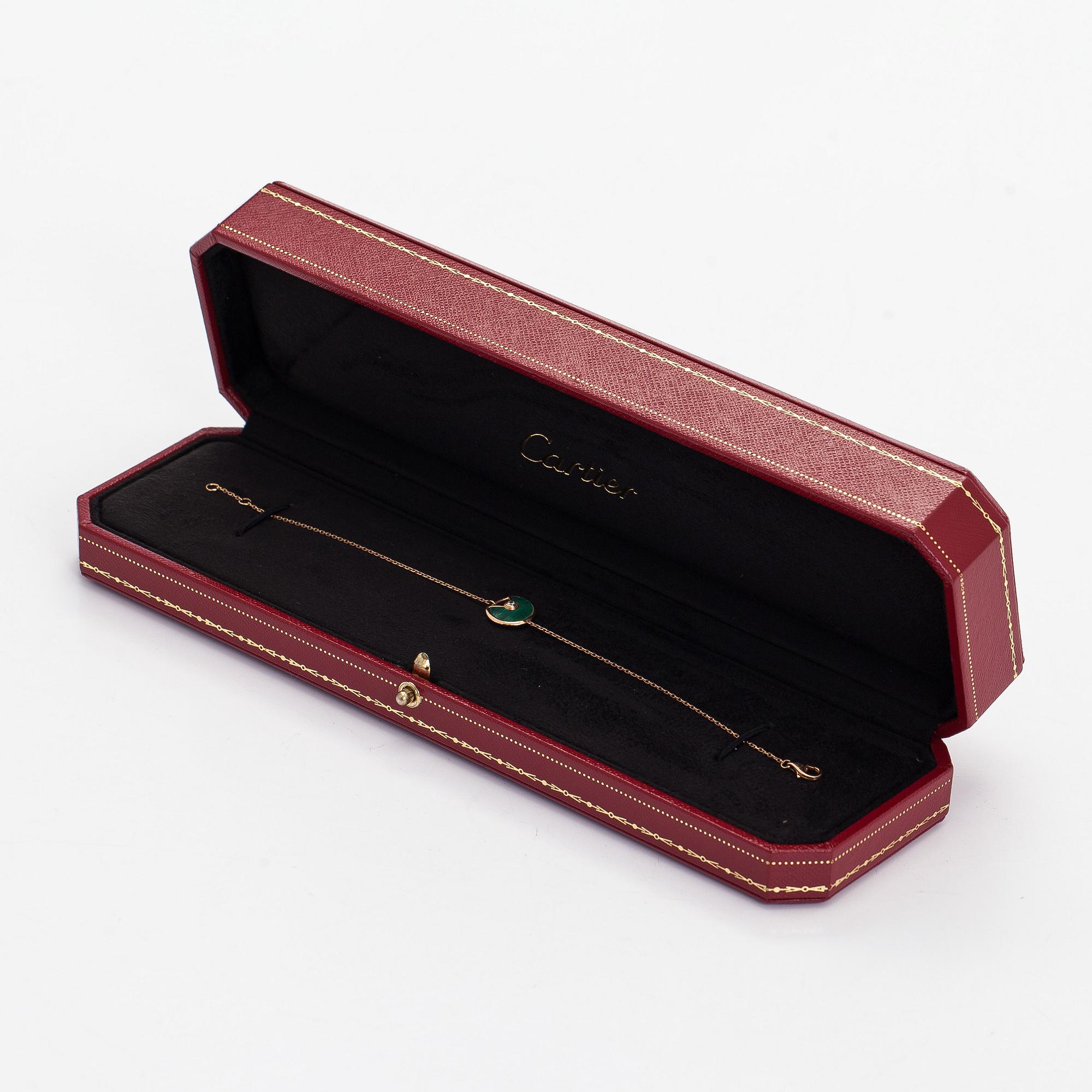 Cartier, an 18K gold "Amulette de Cartier" bracelet with malachite and a brilliant-cut diamond.