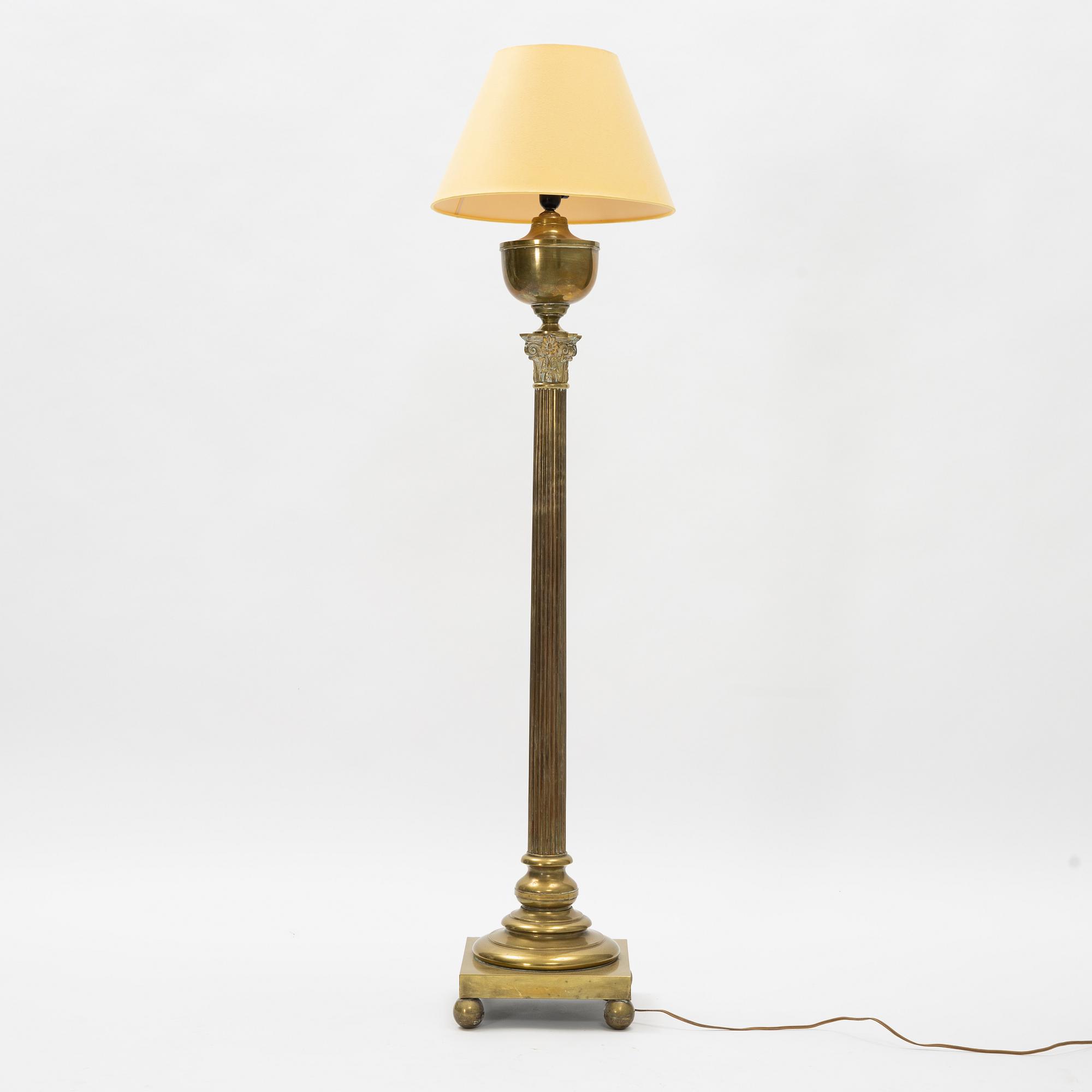 A brass floor lamp, circa 1900.