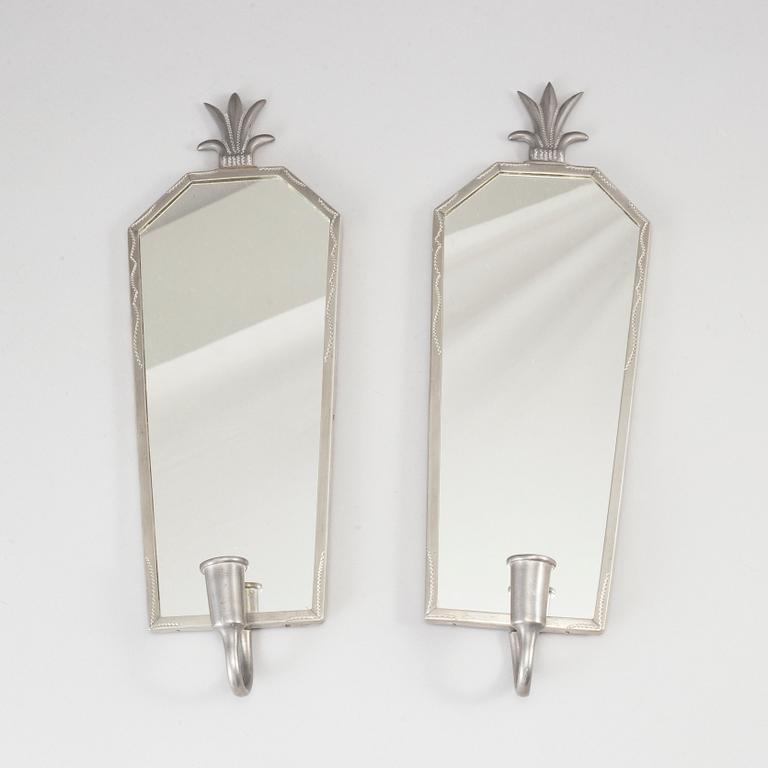 A pewter Art Deco mirror and a pair of wall scones, 1930s.